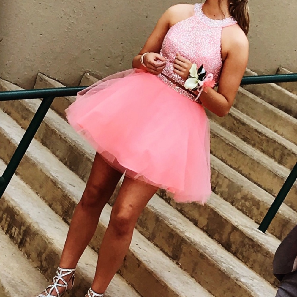 Formal prom dress is size 8 neon coral orange peach with open back. 2 piece